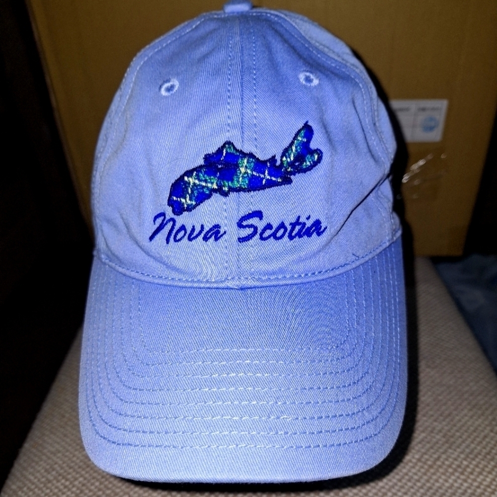 A Nova Scotia ball cap with adjustable strap.Light blue with embroidery